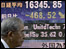 A Japanese man looks at stock market information in Tokyo