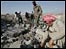 Men search through the rubble in the Lebanese village of Qaa