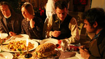 Men and women eating Christmas dinner