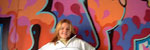 Cindy Brogan infront of decorative graffiti