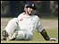 Michael Vaughan grimaces in pain before being helped off the field