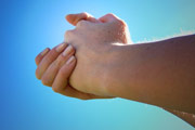 Hands clasped as though pleading