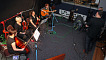 Sarah Howells from Paper Aeroplanes on guitar with string musicians