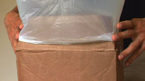 Holding the bin bag carefully in place
