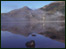 Still lake with mountains behind