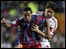 Barcelona's Ronaldinho is held by AC Milan captain Costacurta